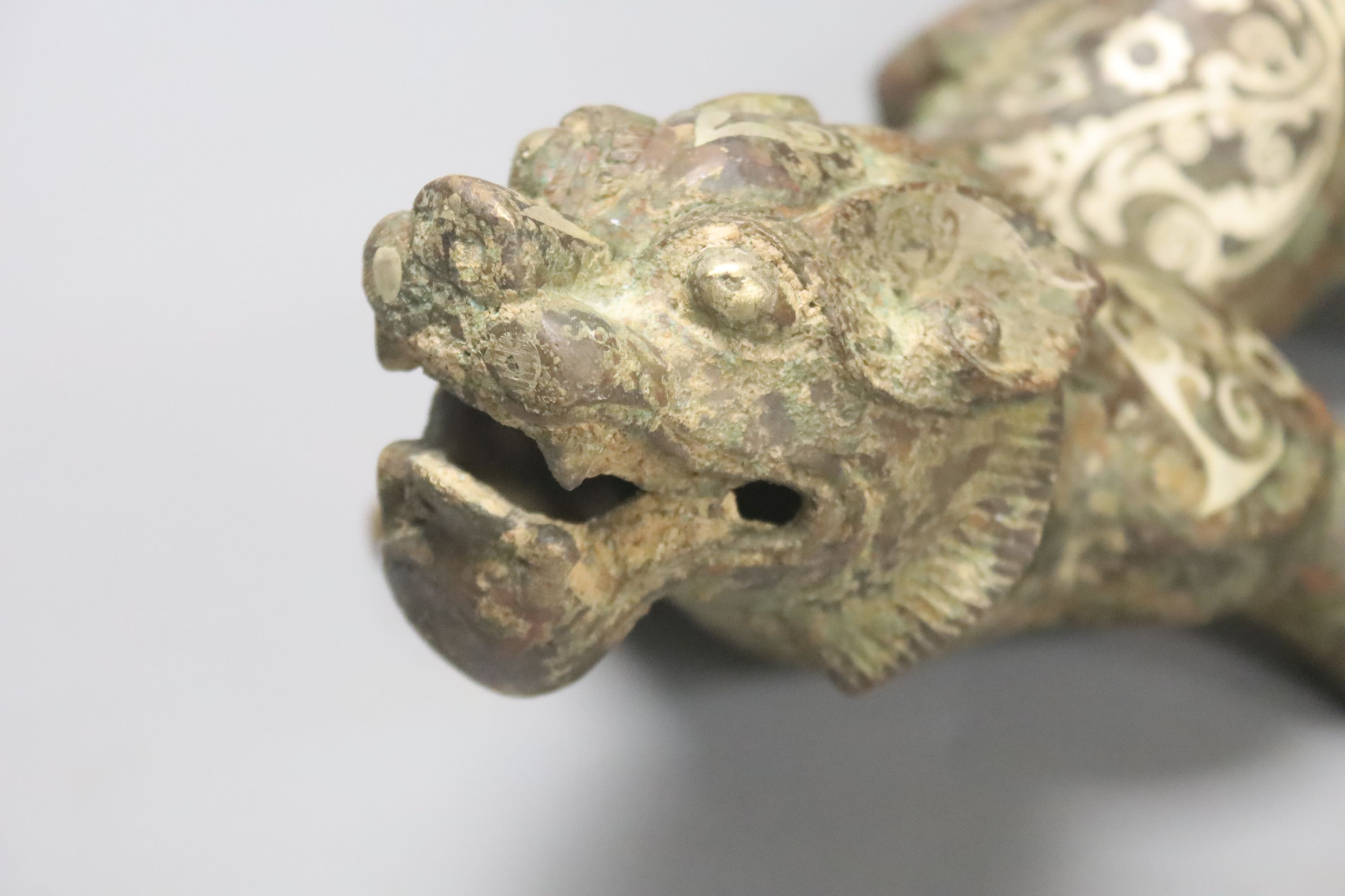 A Chinese inlaid bronze figure of a lion dog, Han dynasty style